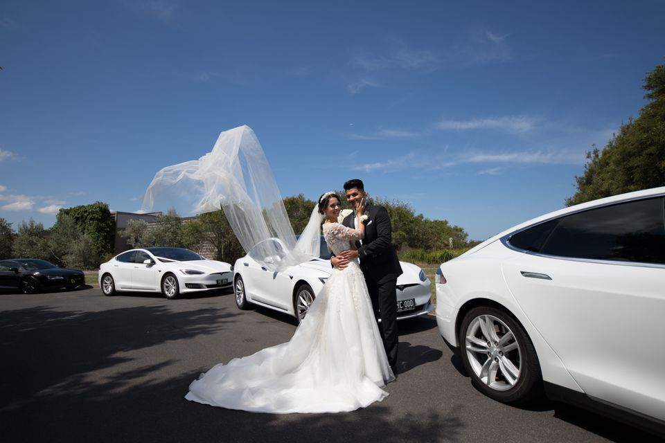 Wedding couple in front of Tesla Model S.